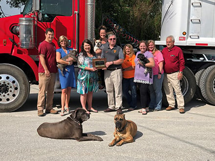 The family in front of a red truck